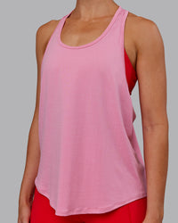 Woman wearing AeroFLX+ Drop Armhole Seamless Tank - Candy Pink | Model:Paris | Size:S