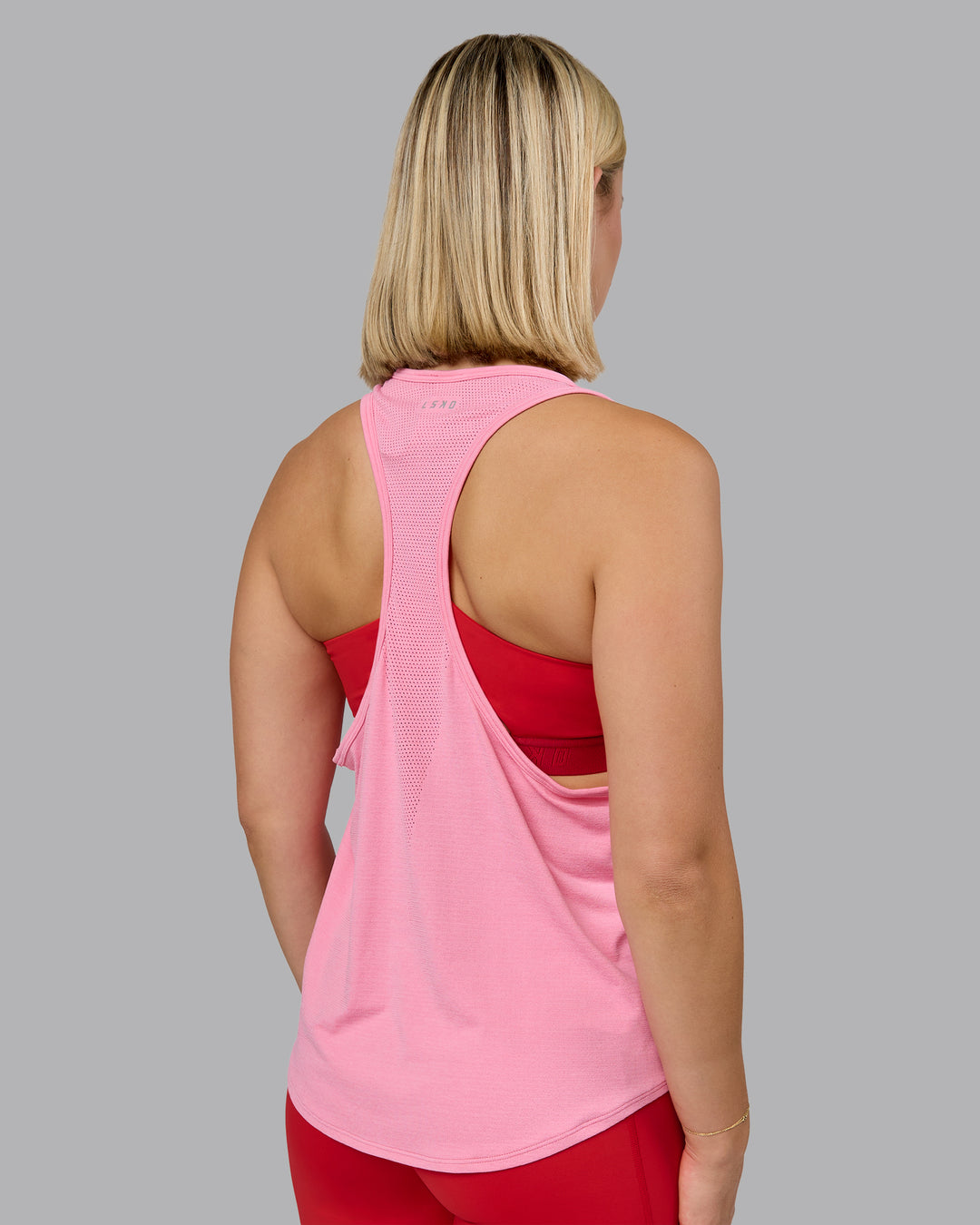 Woman wearing AeroFLX+ Drop Armhole Seamless Tank - Candy Pink | Model:Halle | Size:S