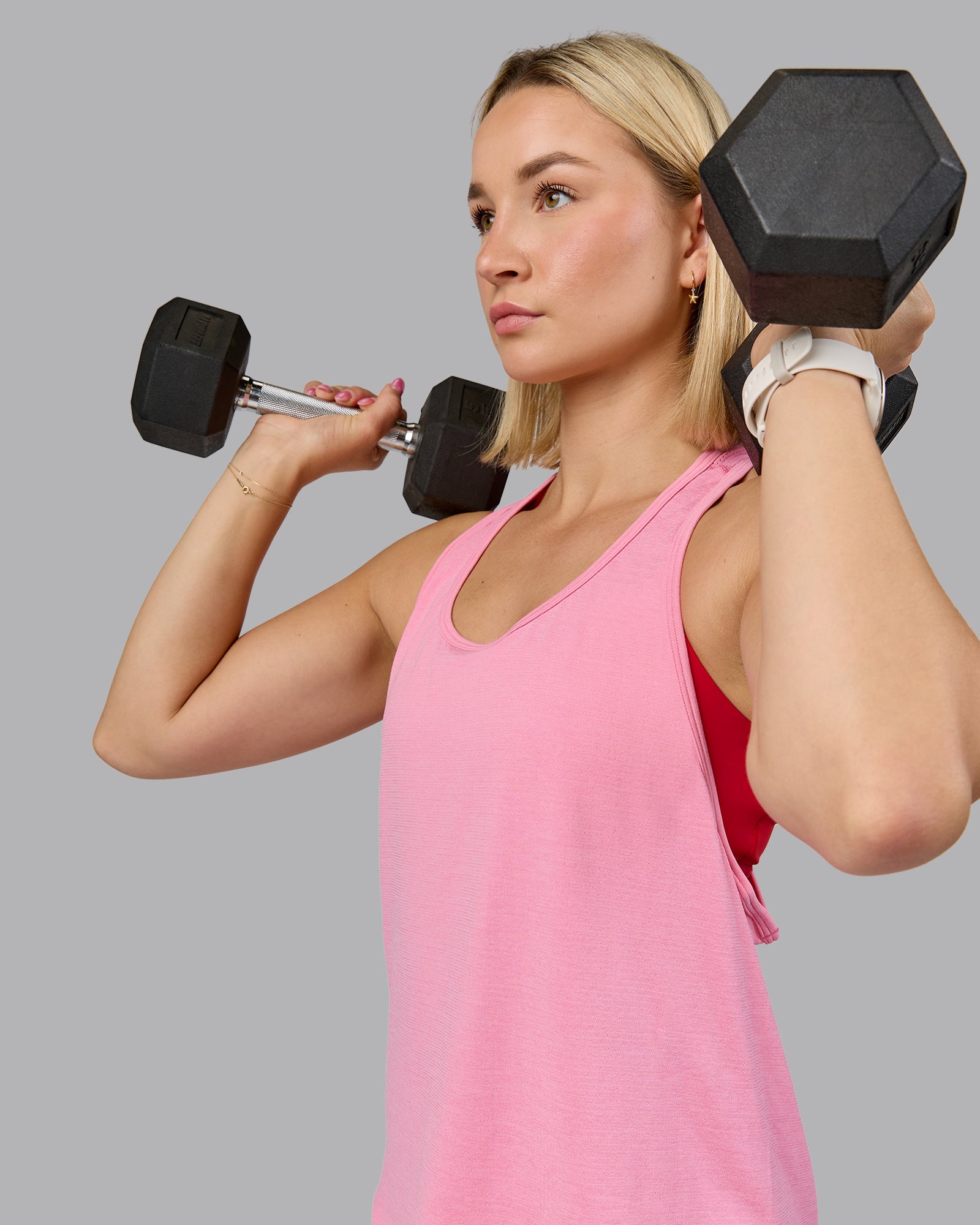 Woman wearing AeroFLX+ Drop Armhole Seamless Tank - Candy Pink | Model:Halle | Size:S