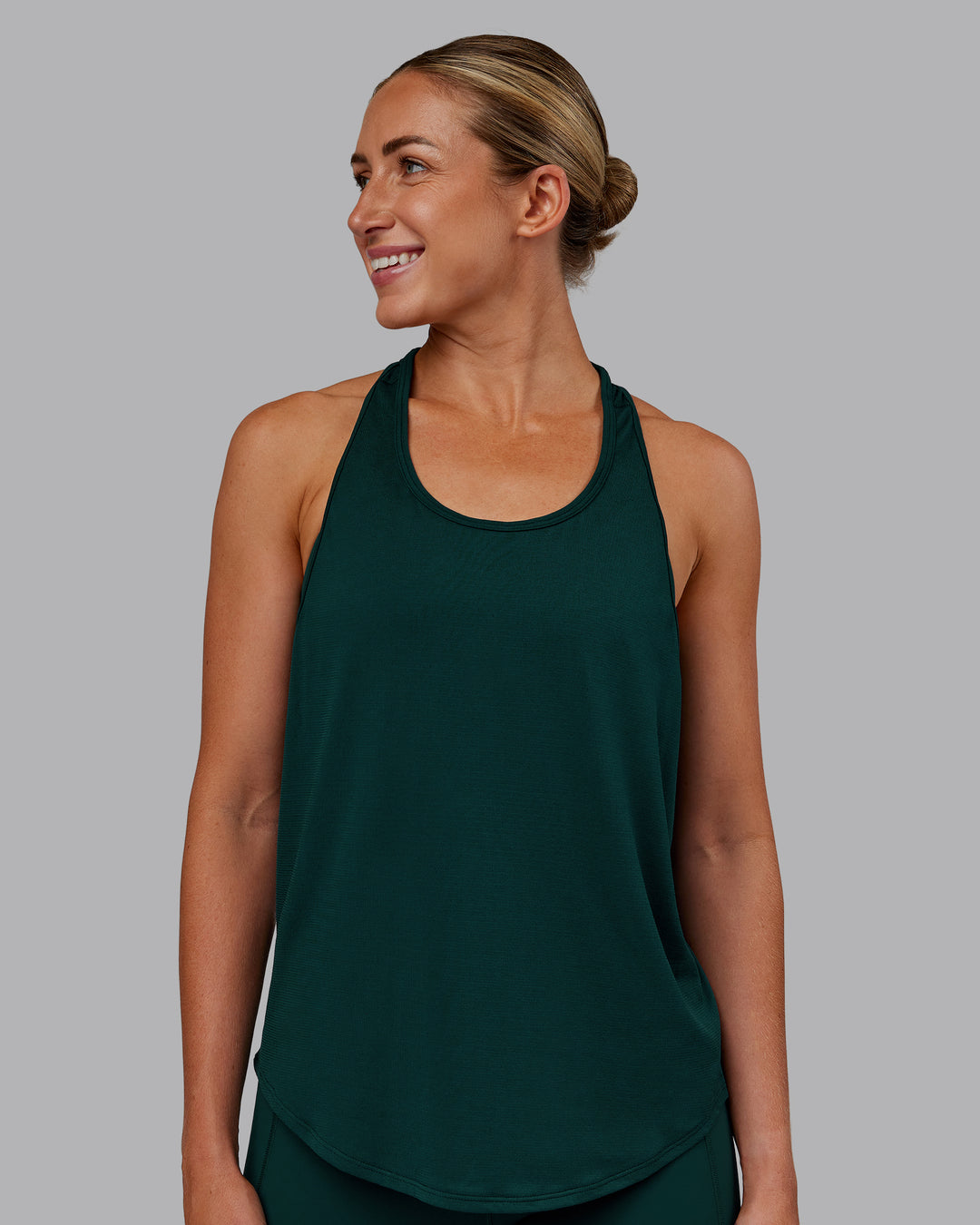 Woman wearing AeroFLX+ Drop Armhole Seamless Tank - Dark Moss | Model:Paris | Size:S