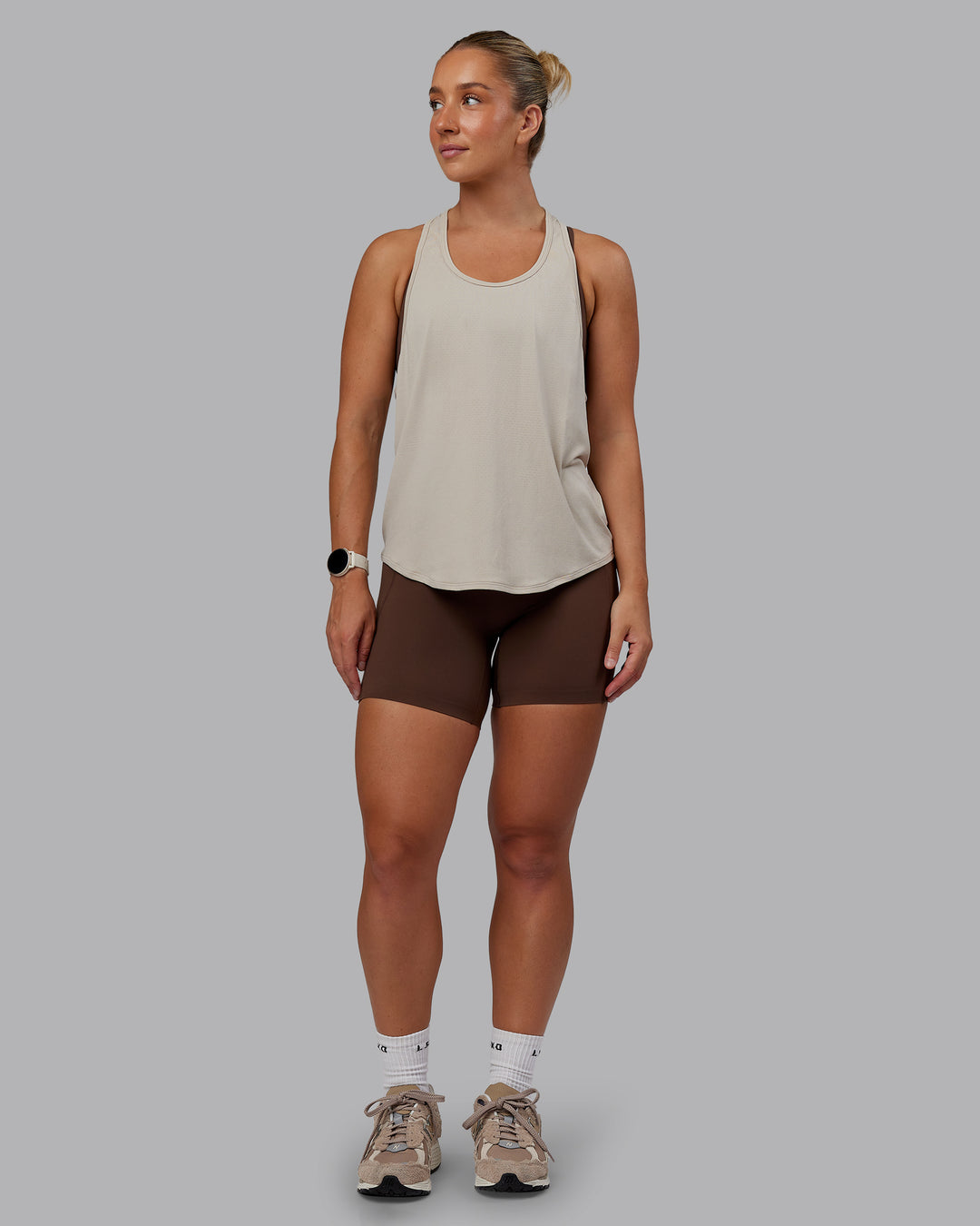 Woman wearing AeroFLX+ Drop Armhole Seamless Tank - Shale Beige | Model:Lyss | Size:S
