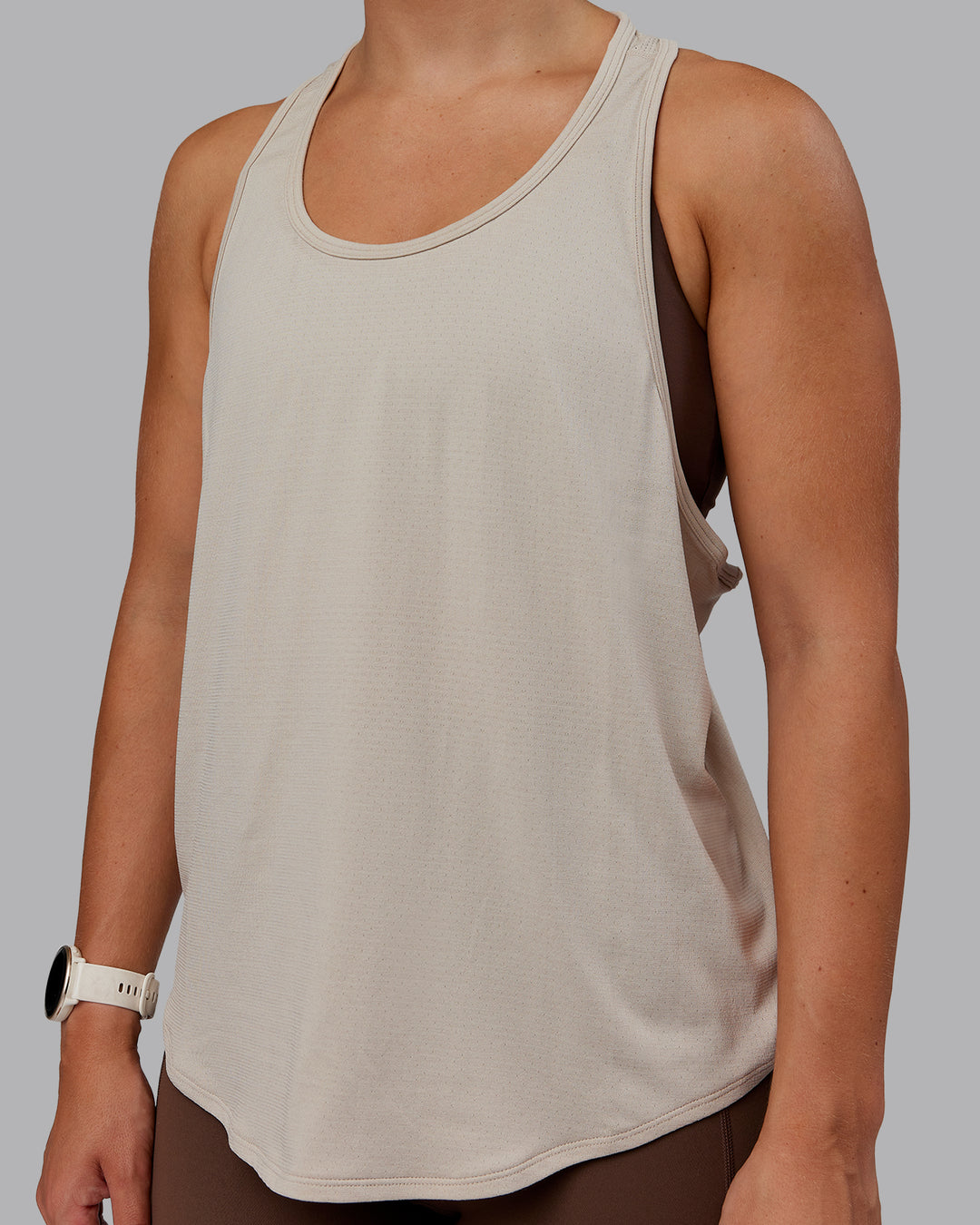 Woman wearing AeroFLX+ Drop Armhole Seamless Tank - Shale Beige | Model:Lyss | Size:S