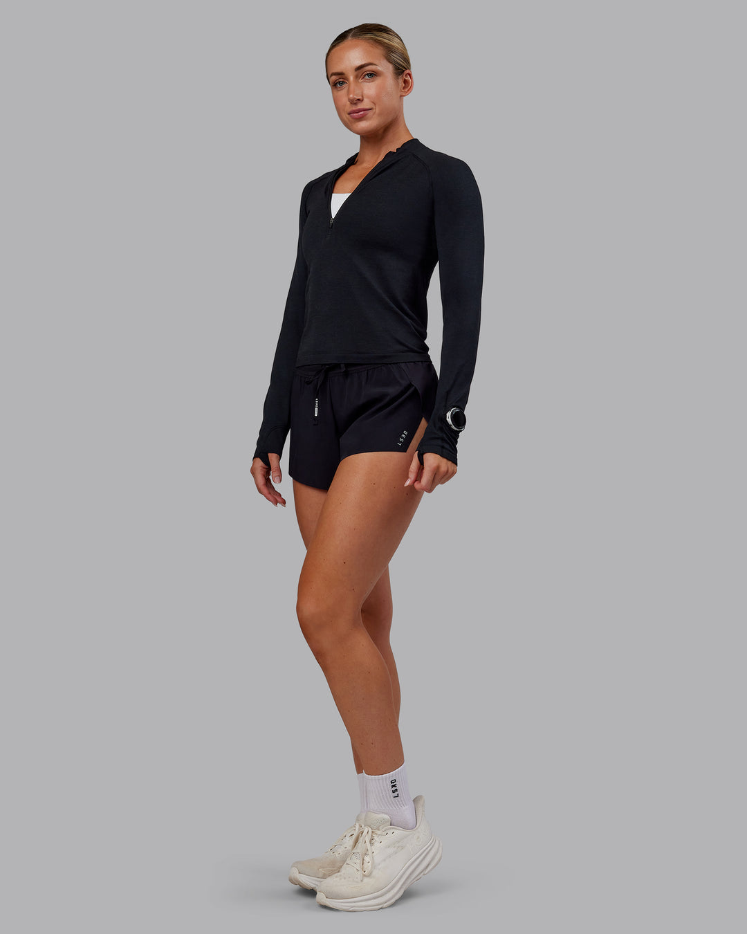 Woman wearing AeroFLX+ Long Sleeve Half Zip - Black Marl | Model:Paris | Size:S