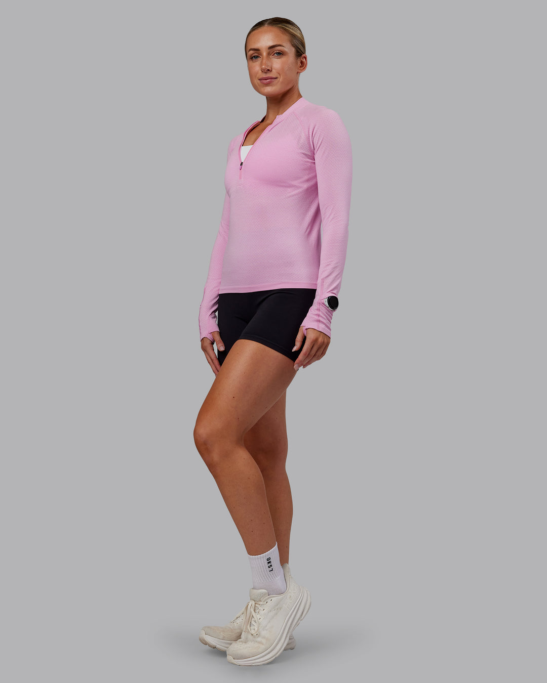 Woman wearing AeroFLX+ Long Sleeve Half Zip - Bubblegum/Pirouette | Model:Paris | Size:S