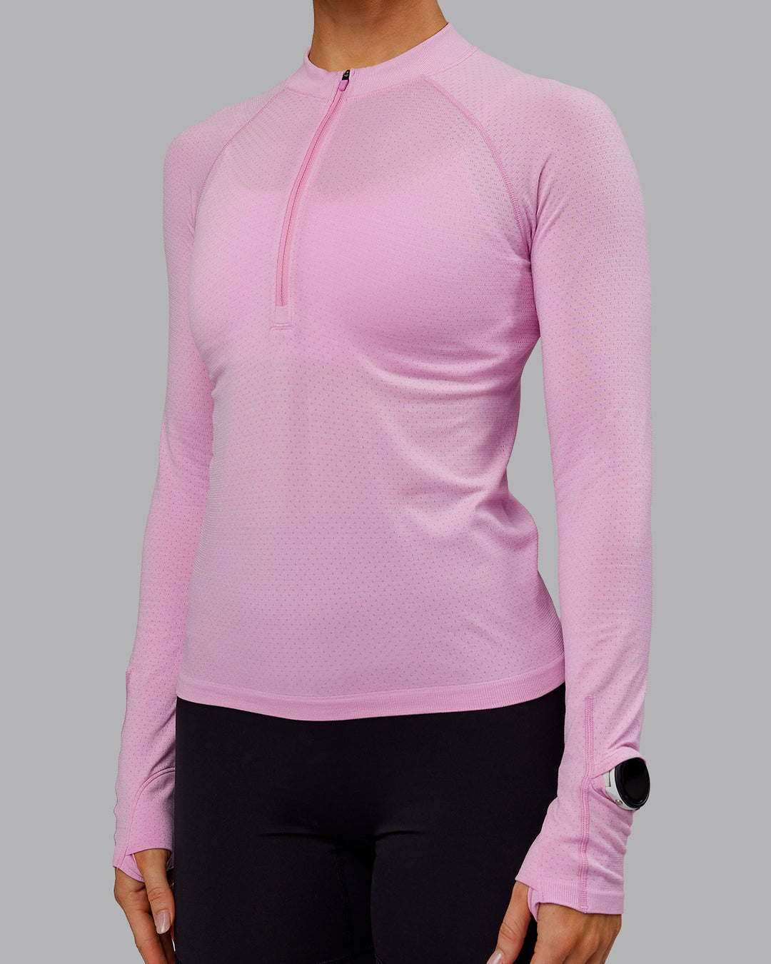 Woman wearing AeroFLX+ Long Sleeve Half Zip - Bubblegum/Pirouette | Model:Paris | Size:S