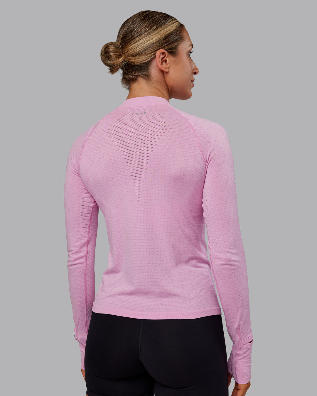 Woman wearing AeroFLX+ Long Sleeve Half Zip - Bubblegum/Pirouette | Model:Paris | Size:S