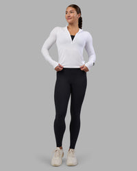 Woman wearing AeroFLX+ Long Sleeve Half Zip - White/White | Model:Hannah | Size:S
