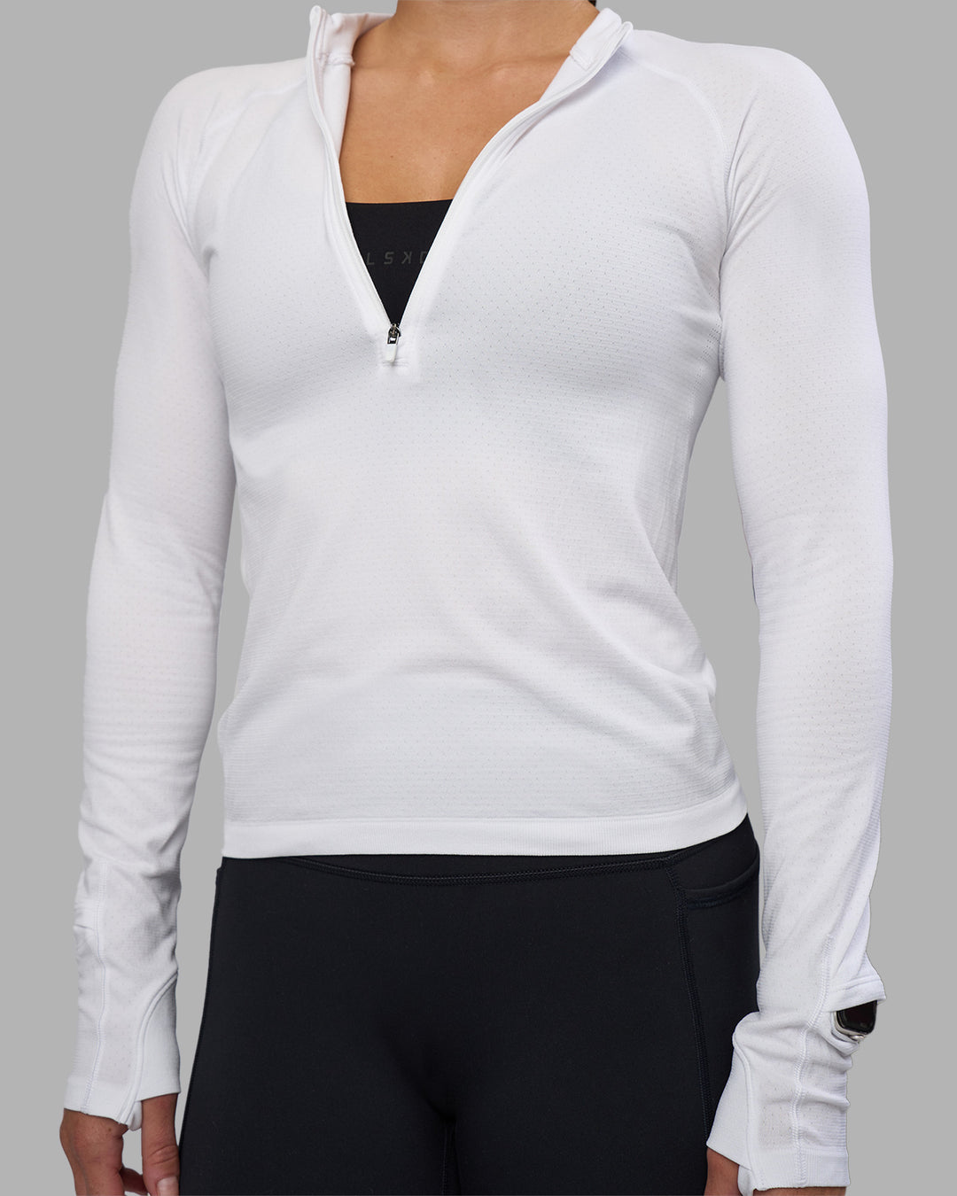 Woman wearing AeroFLX+ Long Sleeve Half Zip - White/White | Model:Hannah | Size:S