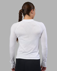 Woman wearing AeroFLX+ Long Sleeve Half Zip - White/White | Model:Hannah | Size:S