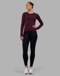 Woman wearing AeroFLX+ Seamless Long Sleeve Tee - Cherry Lacquer/Cherry Lacquer | Model:Charlize | Size:S