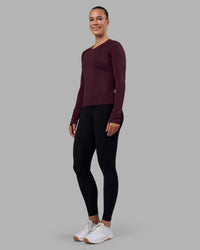 Woman wearing AeroFLX+ Seamless Long Sleeve Tee - Cherry Lacquer/Cherry Lacquer | Model:Charlize | Size:S