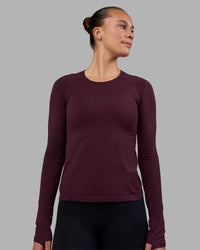 Woman wearing AeroFLX+ Seamless Long Sleeve Tee - Cherry Lacquer/Cherry Lacquer | Model:Charlize | Size:S