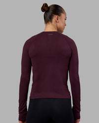 Woman wearing AeroFLX+ Seamless Long Sleeve Tee - Cherry Lacquer/Cherry Lacquer | Model:Charlize | Size:S