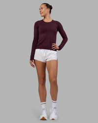 Woman wearing AeroFLX+ Seamless Long Sleeve Tee - Cherry Lacquer/Cherry Lacquer | Model:Charlize | Size:S