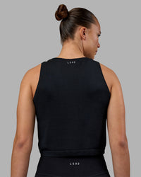 Woman wearing AeroFLX+ Seamless Skimmer Tank - Black Marl | Model:Charlize | Size:S