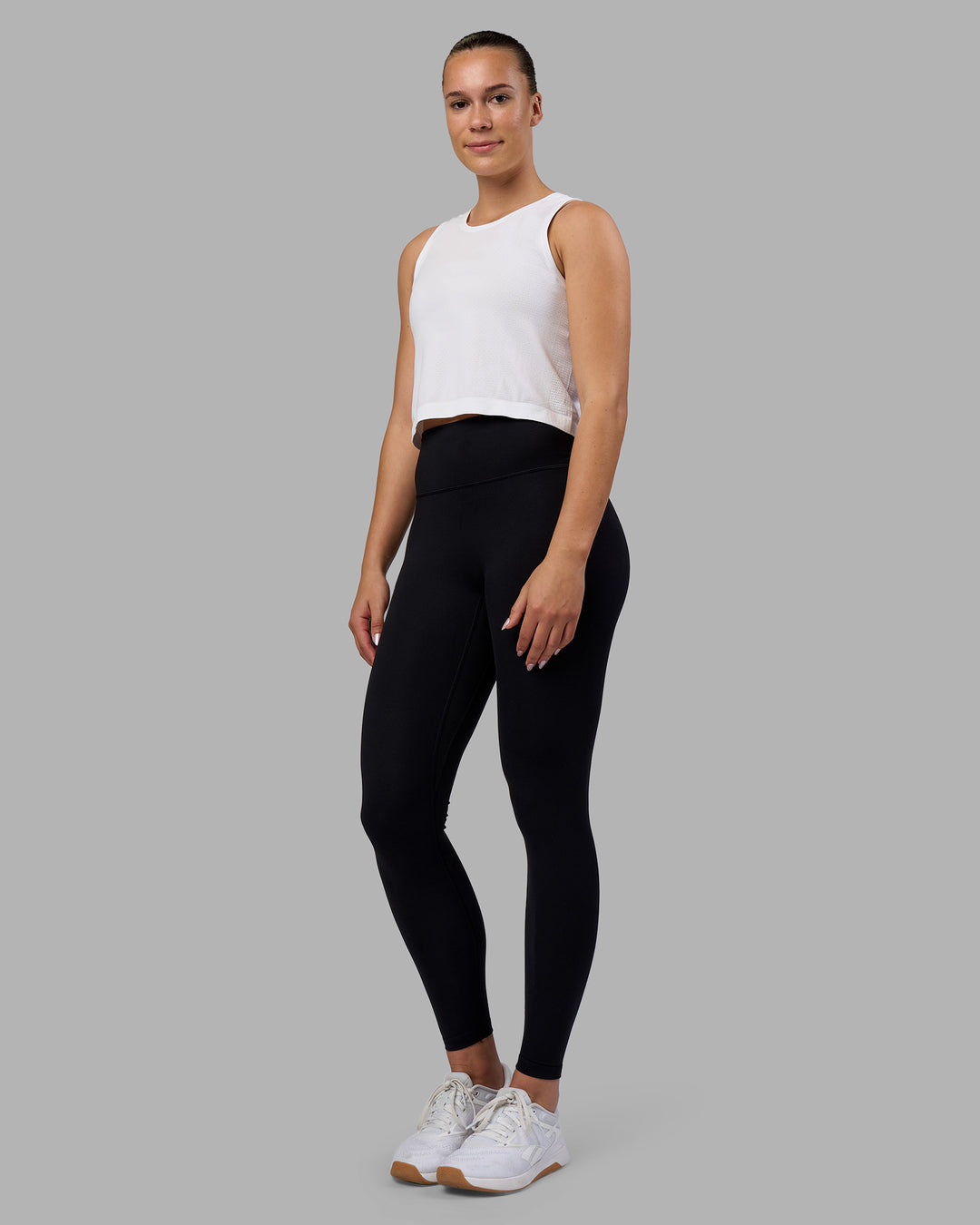 Woman wearing AeroFLX+ Seamless Skimmer Tank - White/White | Model:Charlize | Size:S