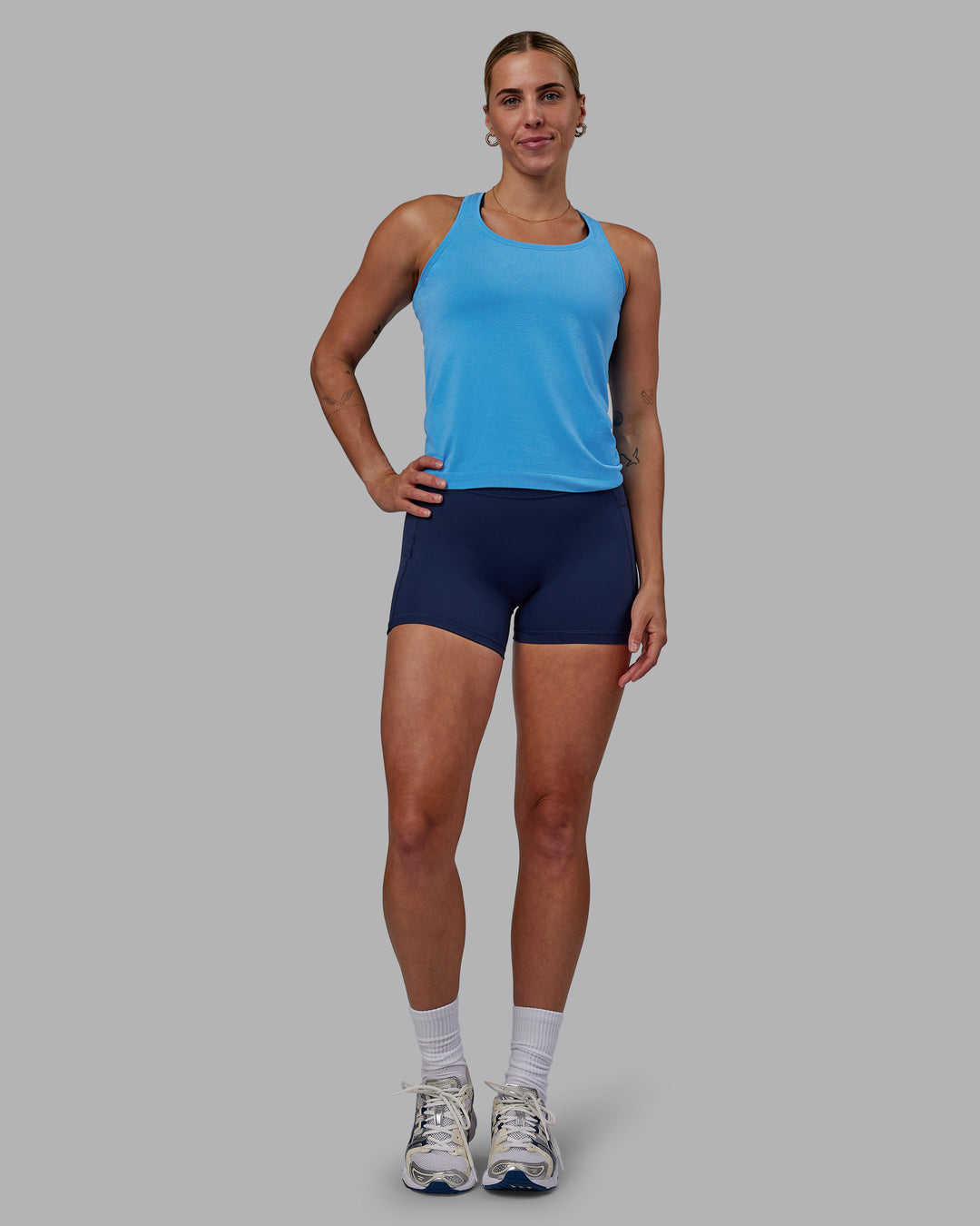 Woman wearing AeroFLX+ Seamless Tank - Azure Blue