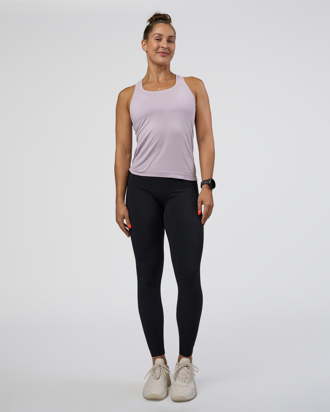 Woman wearing AeroFLX+ Seamless Tank - Fair Orchid/Fair Orchid | Model:Abbey | Size:S