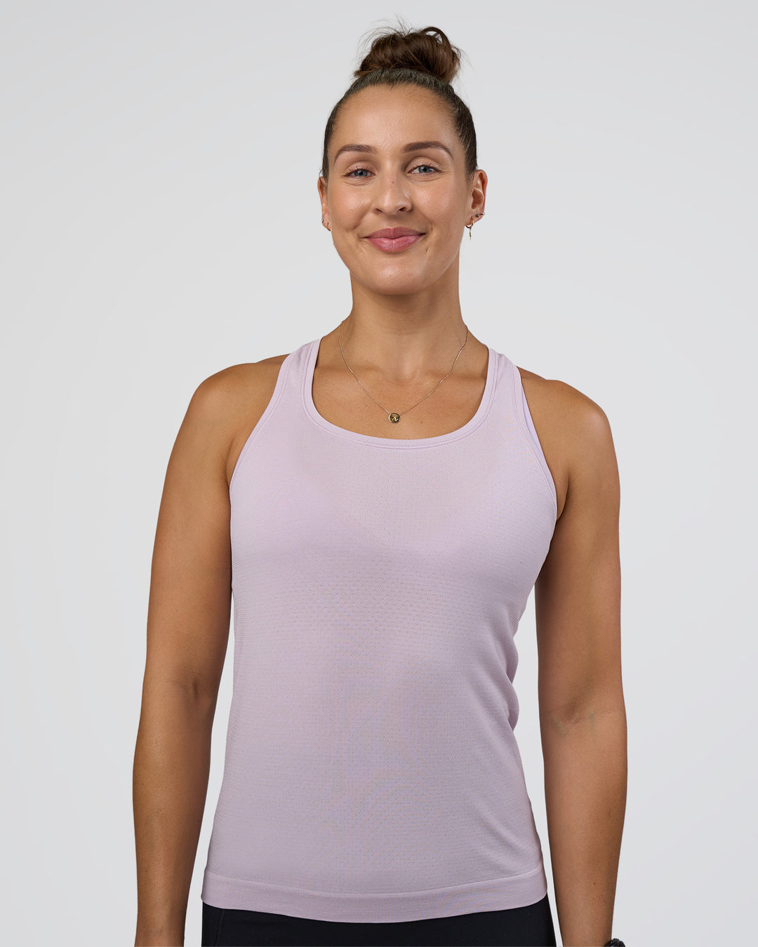 Woman wearing AeroFLX+ Seamless Tank - Fair Orchid/Fair Orchid | Model:Abbey | Size:S