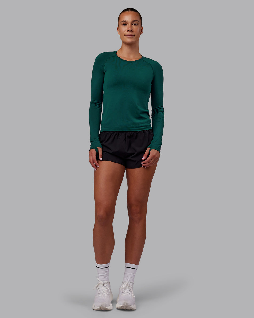 Woman wearing AeroFLX+ Seamless Long Sleeve Tee - Dark Moss/Dark Moss | Model:Charlize | Size:S