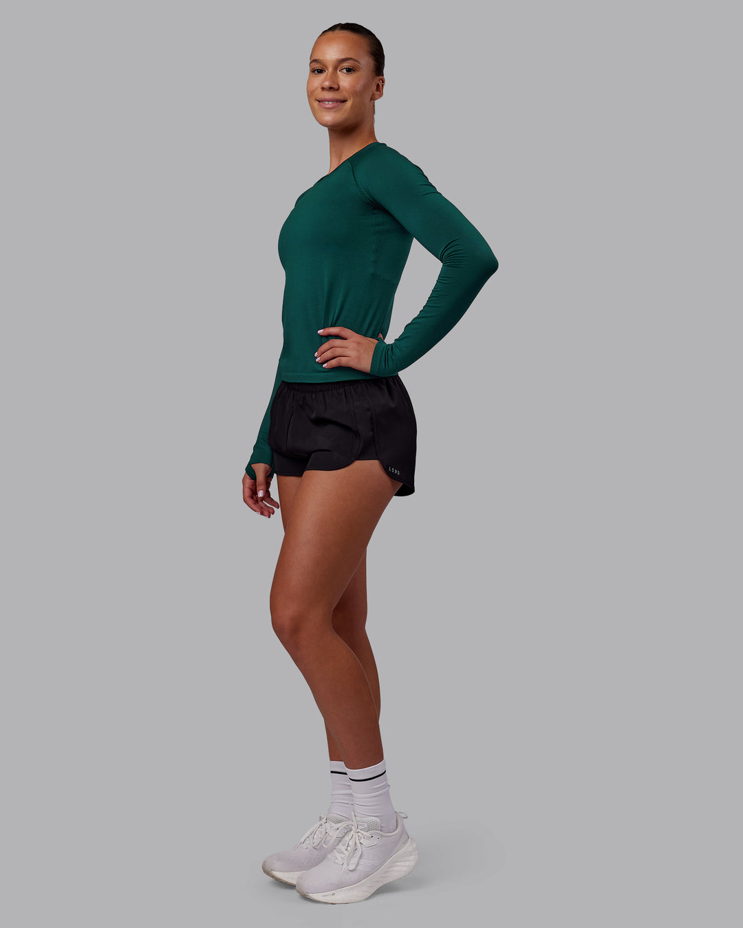 Woman wearing AeroFLX+ Seamless Long Sleeve Tee - Dark Moss/Dark Moss | Model:Charlize | Size:S