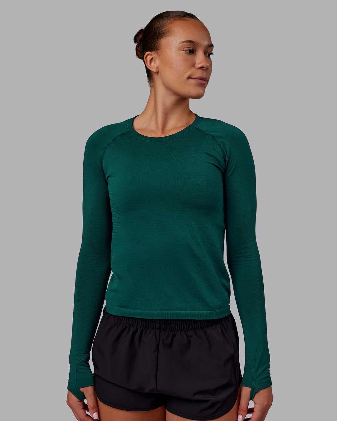 Woman wearing AeroFLX+ Seamless Long Sleeve Tee - Dark Moss/Dark Moss | Model:Charlize | Size:S