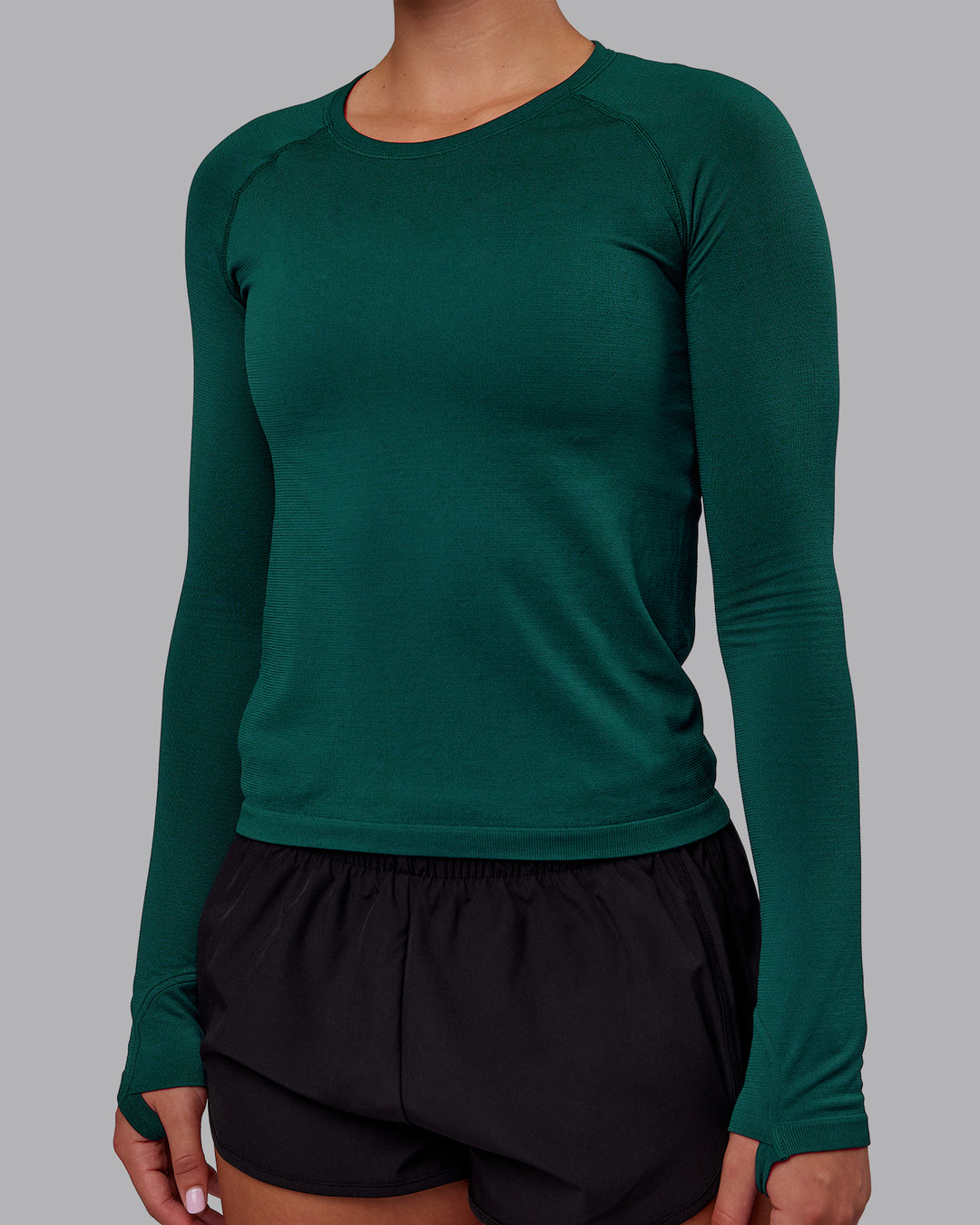 Woman wearing AeroFLX+ Seamless Long Sleeve Tee - Dark Moss/Dark Moss | Model:Charlize | Size:S