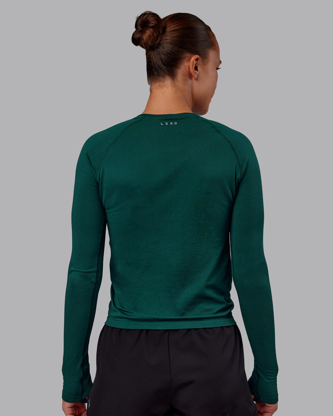 Woman wearing AeroFLX+ Seamless Long Sleeve Tee - Dark Moss/Dark Moss | Model:Charlize | Size:S