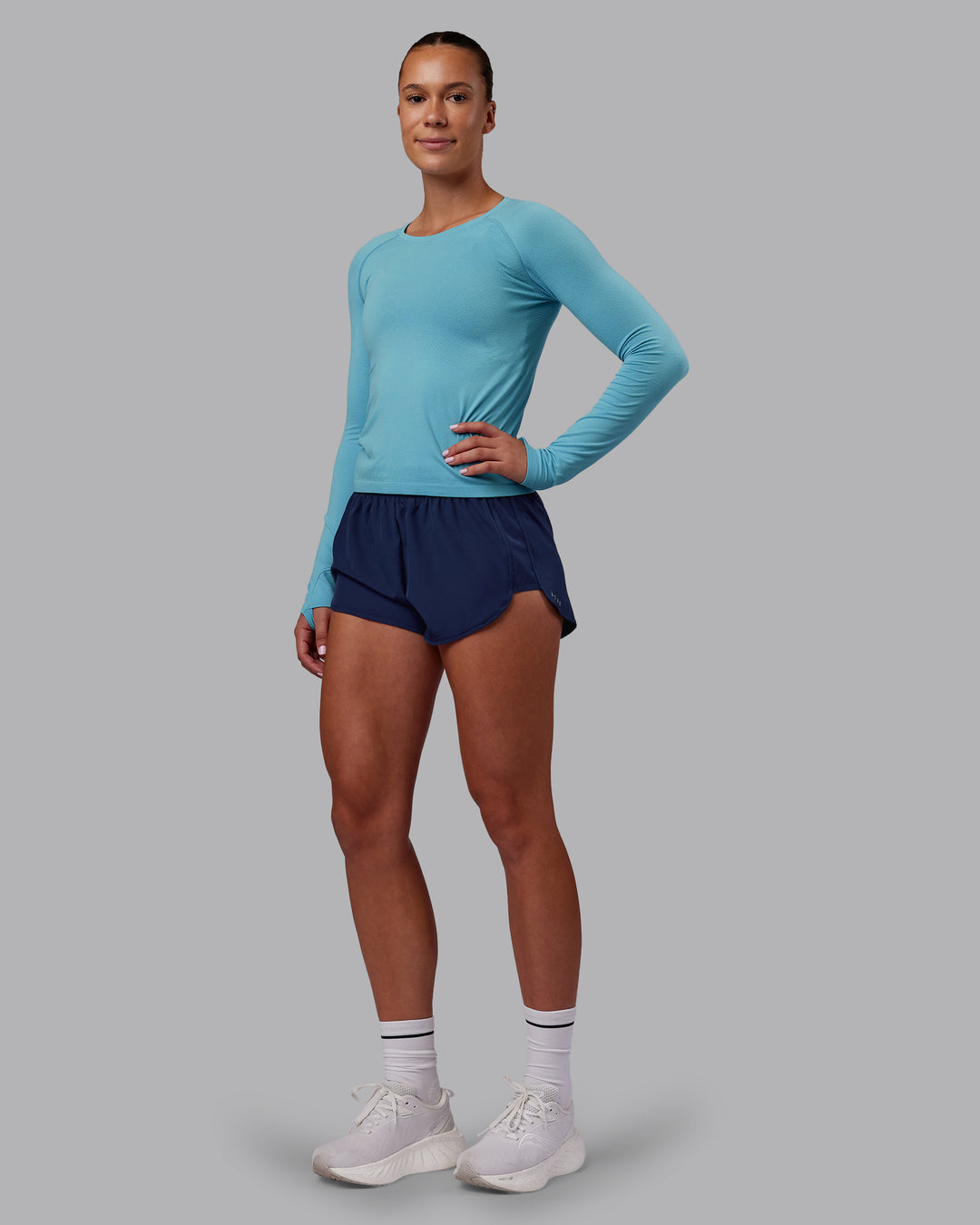 Woman wearing AeroFLX+ Seamless Long Sleeve Tee - Retro Blue/Retro Blue | Model:Charlize | Size:S