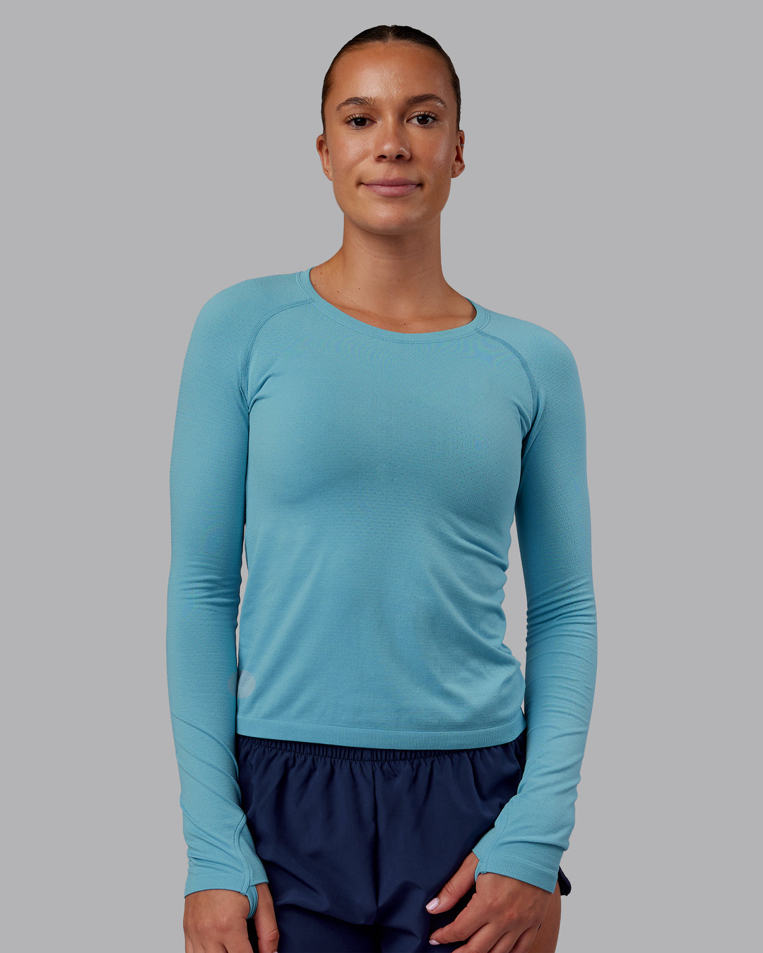 Woman wearing AeroFLX+ Seamless Long Sleeve Tee - Retro Blue/Retro Blue | Model:Charlize | Size:S