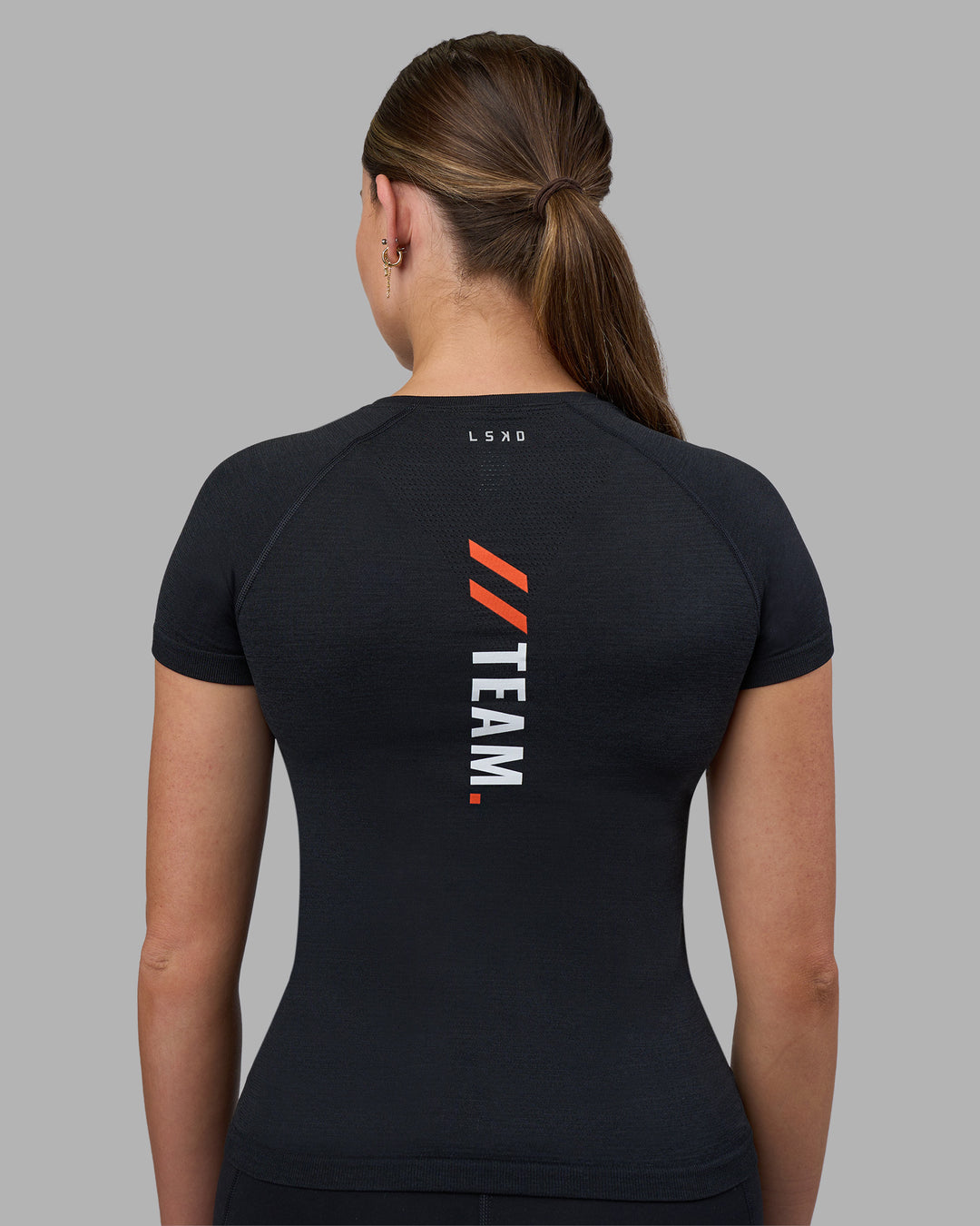 Woman wearing Fitstop AeroFLX+ Seamless Tee - Black | Model:Jade | Size:S