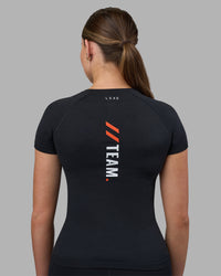 Woman wearing Fitstop AeroFLX+ Seamless Tee - Black | Model:Jade | Size:S