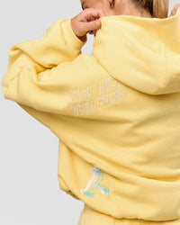 Woman wearing Zola Oversized Hoodie - Lemon | Model:Issy | Size:S