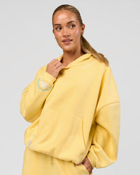 Woman wearing Zola Oversized Hoodie - Lemon | Model:Issy | Size:S