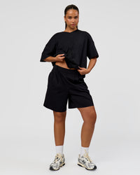 Woman wearing 86 V-Neck Oversized Tee - Black-Black | Model:Sophia | Size:S 