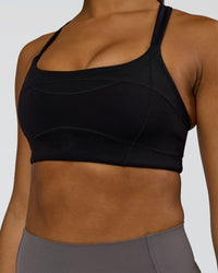 Woman wearing Inertia Sports Bra - Black | Model:Rosie | Size:S