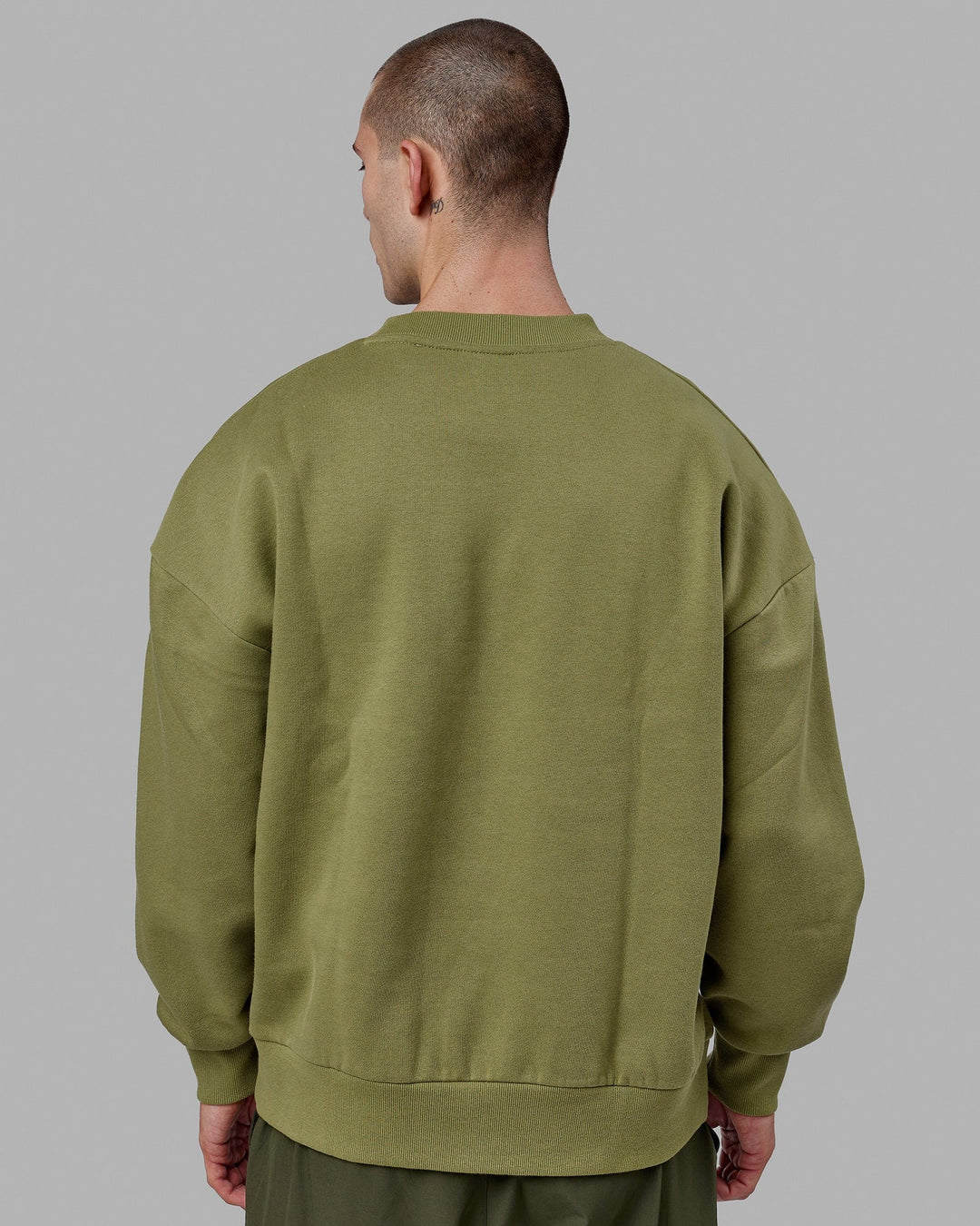 Man wearing Unisex Stamped Sweater Oversize - Moss Stone