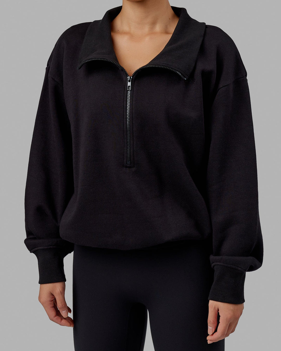 Woman wearing Wind Down FLXFleece 1/4 Zip Sweater - Black