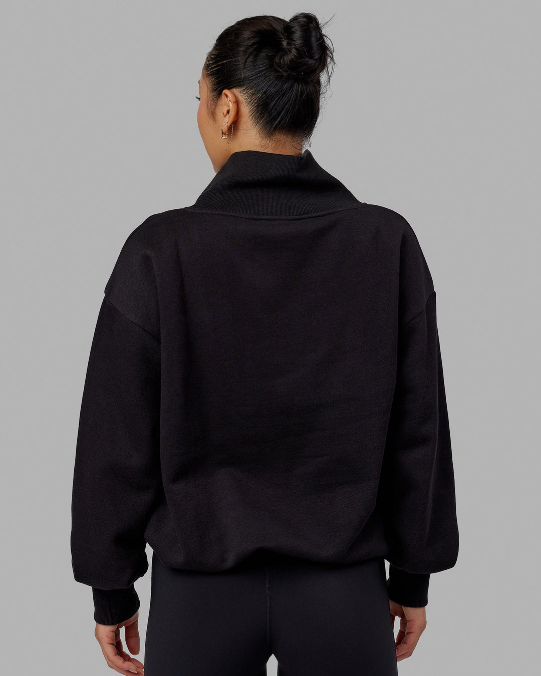 Woman wearing Wind Down FLXFleece 1/4 Zip Sweater - Black
