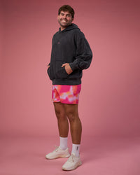 Man wearing BCAM Washed Unisex Oversized Hoodie - Black Washed-Pink | Model:Fletcher | Size:XL