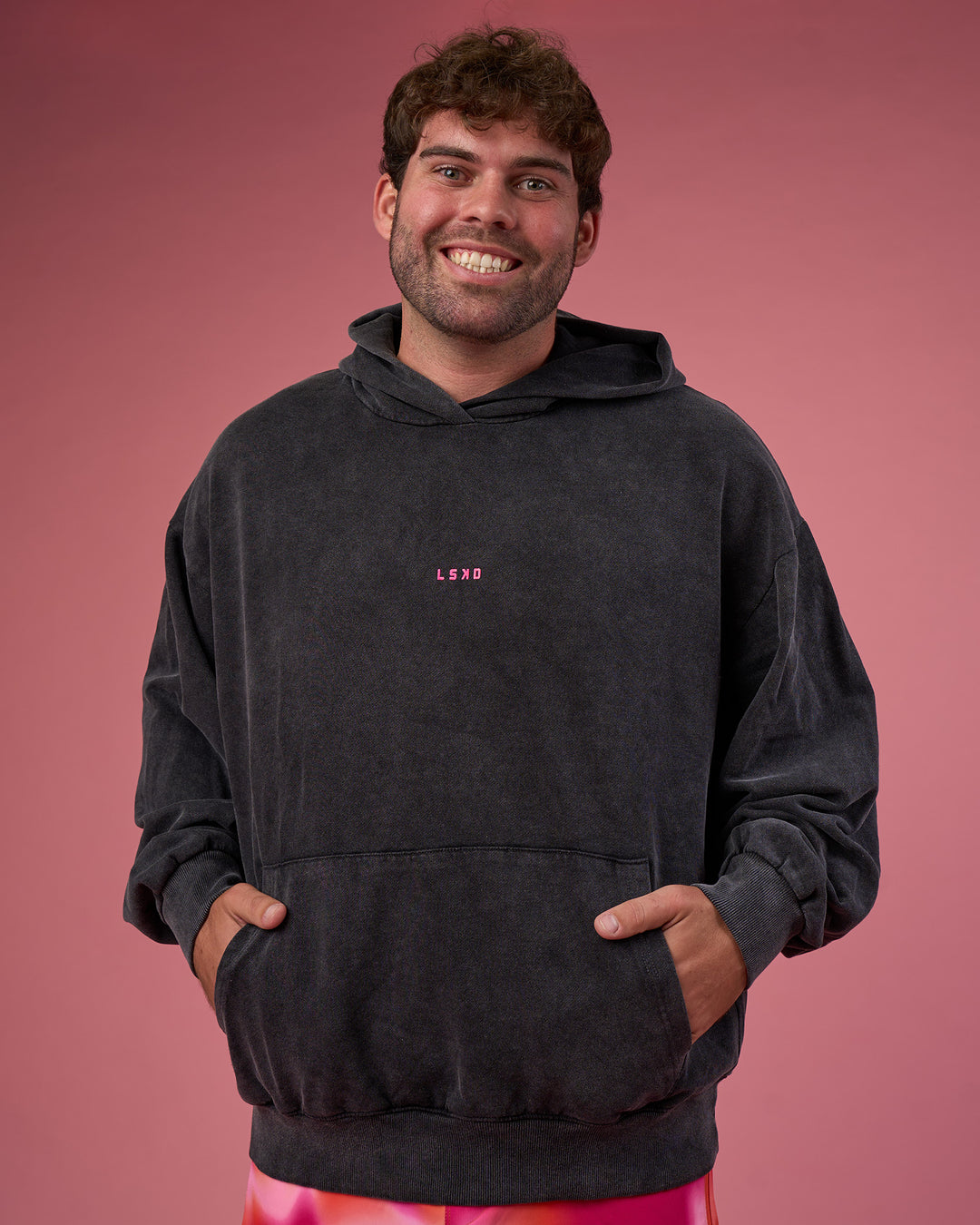 Man wearing BCAM Washed Unisex Oversized Hoodie - Black Washed-Pink | Model:Fletcher | Size:XL