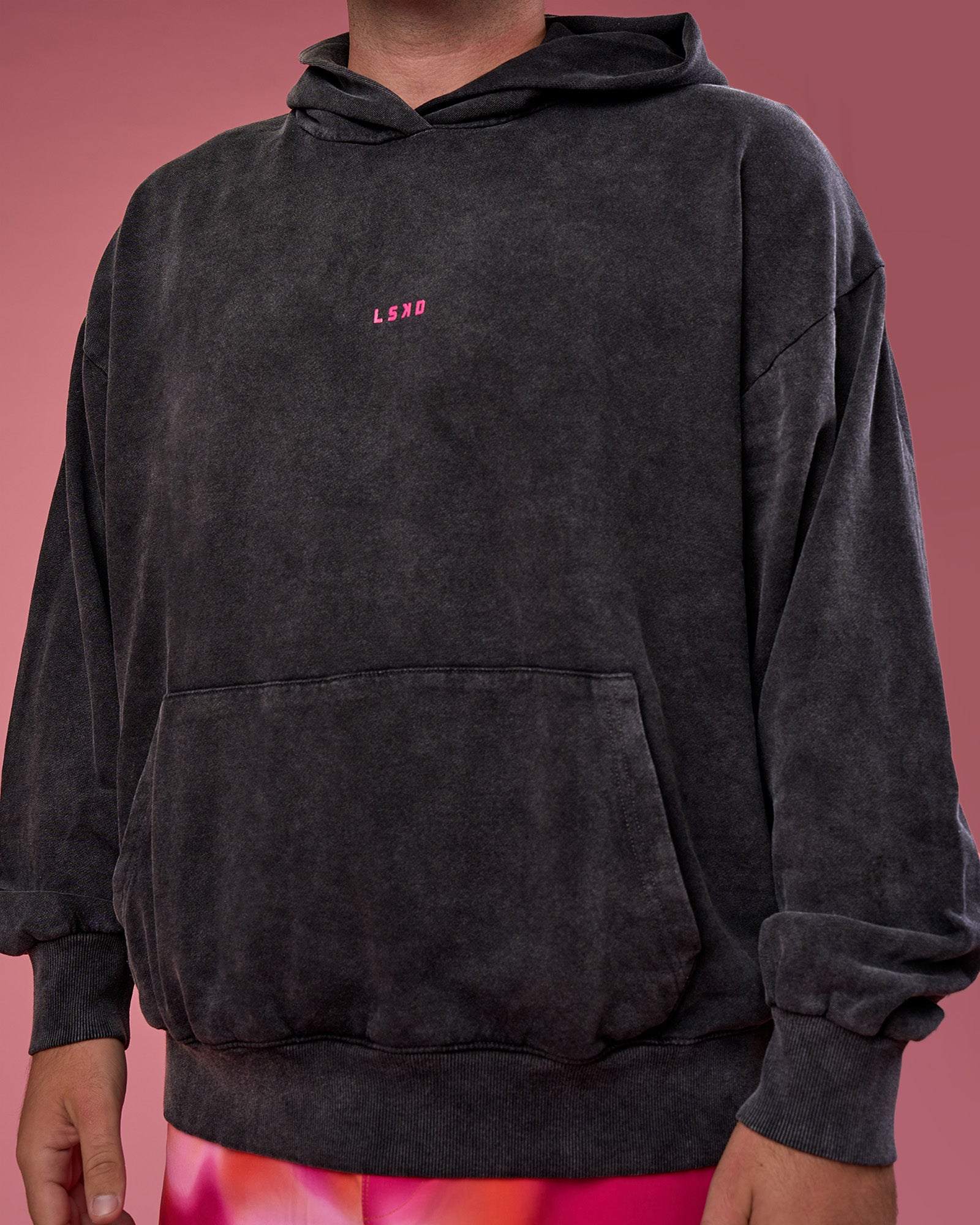 Man wearing BCAM Washed Unisex Oversized Hoodie - Black Washed-Pink | Model:Fletcher | Size:XL