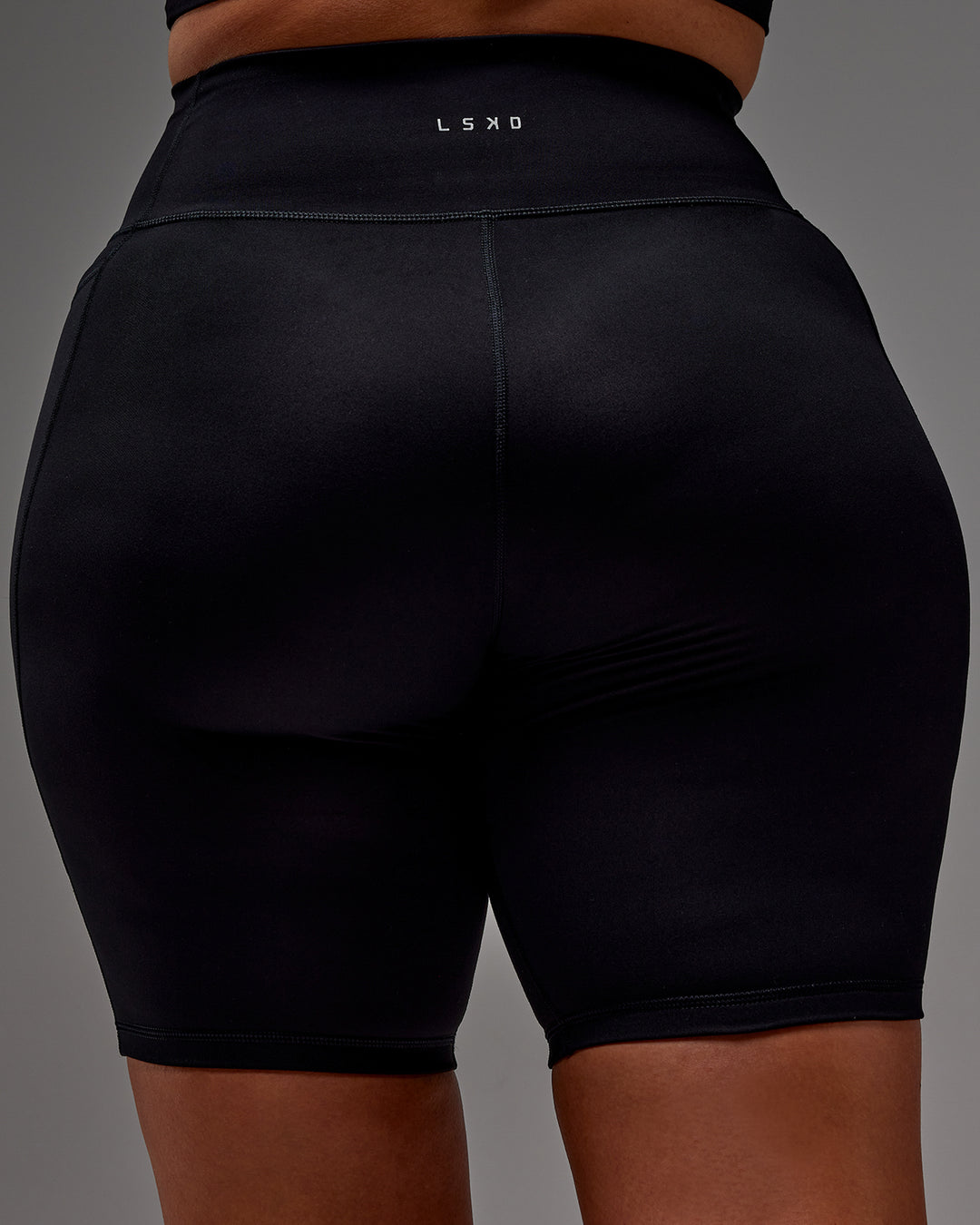 Woman wearing Fusion Ultra High-Rise 9&quot; Short Pockets - Black | Model:Aimee | Size:XL