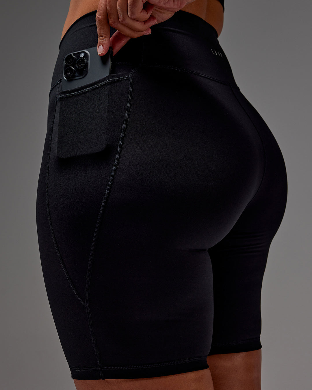 Woman wearing Fusion Ultra High-Rise 9&quot; Short Pockets - Black | Model:Aimee | Size:XL