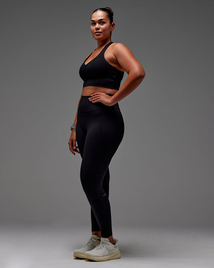Woman wearing Fusion Full Length Tight With Pockets in Black | Model:Aimee | Size:XL
