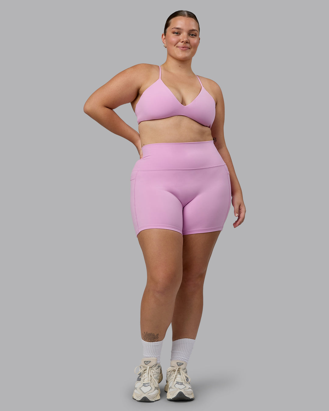 Woman wearing Fusion Ultra High-Rise 4&quot; Short Pockets - Pastel Orchid | Model:Ella | Size:XL