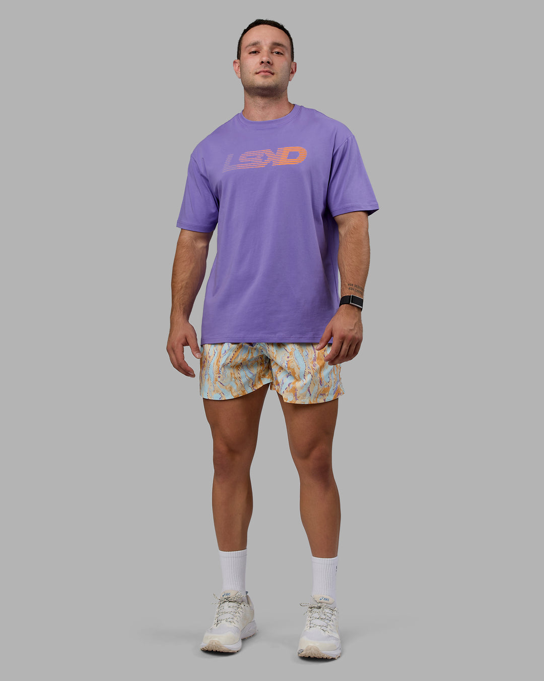Man wearing Unisex Motion FLXCotton Tee Oversize - Dahlia Purple-Vibrant Orange
