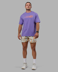 Man wearing Unisex Motion FLXCotton Tee Oversize - Dahlia Purple-Vibrant Orange