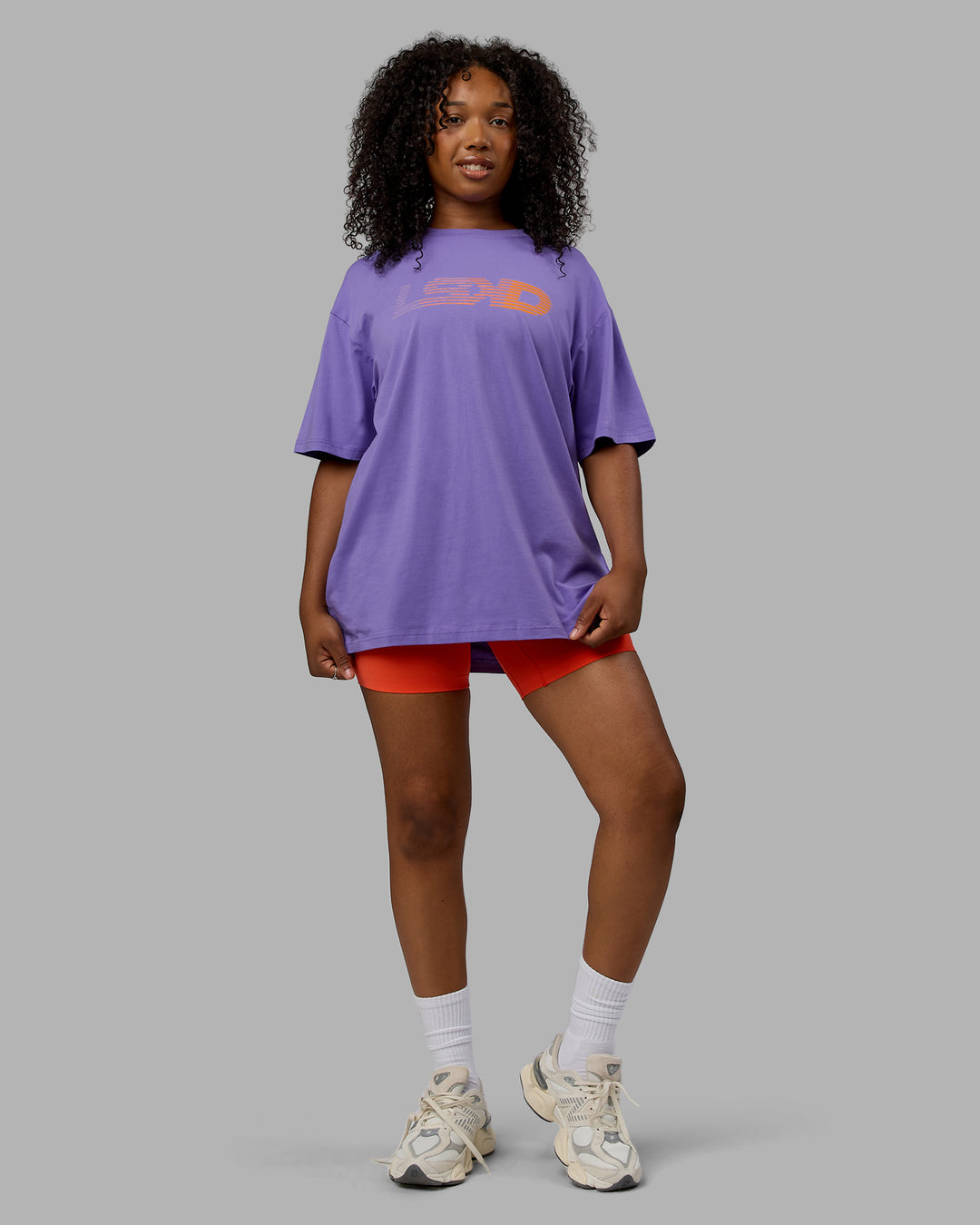 Woman wearing Unisex Motion FLXCotton Tee Oversize - Dahlia Purple-Vibrant Orange