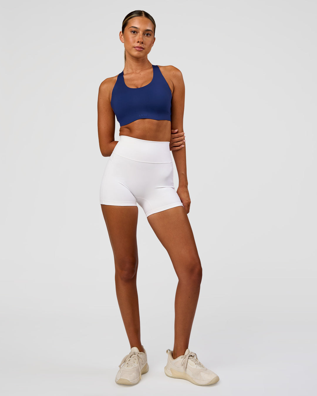 Woman wearing Stability High Support Sports Bra - Midnight Blue | Model:Charli | Size:XS (A-C Cup)